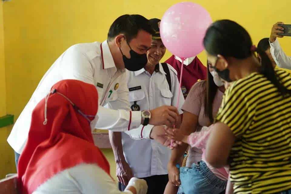 Bupati Kapuas Hulu, Fransiskus Diaan, memberikan balon kepada salah seorang balita yang sedang menjalani imunisasi di Desa Kepala Gurung. (Foto: Istimewa)