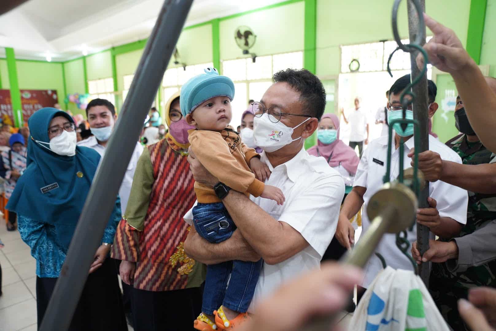 Wali Kota Pontianak, Edi Rusdi Kamtono menggendong balita di sela-sela acara peluncuran Gebyar Penimbangan Massal se-Kecamatan Pontianak Barat. (Foto: Prokopim For KalbarOnline.com)
