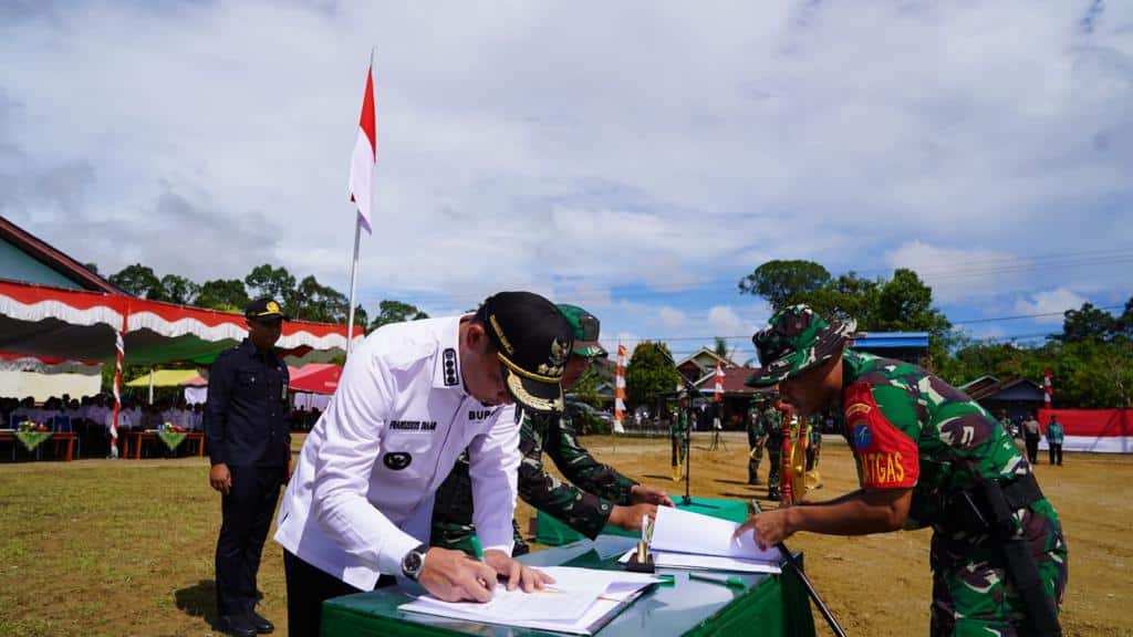Bupati Kapuas Hulu, Fransiskus Diaan menandatangani berita acara kegiatan TMMD ke-116 Tahun 2023, di Desa Menaren, Kecamatan Mentebah, Kabupaten Kapuas Hulu, Rabu (10/05/2023). (Foto: Ishaq)
