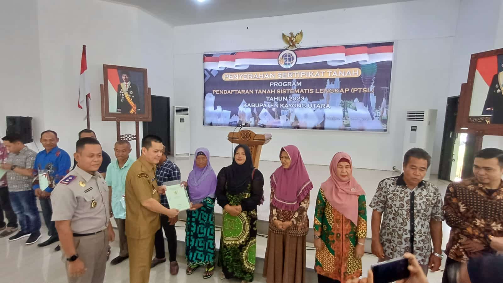 Penyerahan sertifikat tanah program PTSL kepada sejumlah warga di Aula Istana Rakyat, Kecamatan Sukadana, Selasa (14/11/2023). (Foto: Santo)