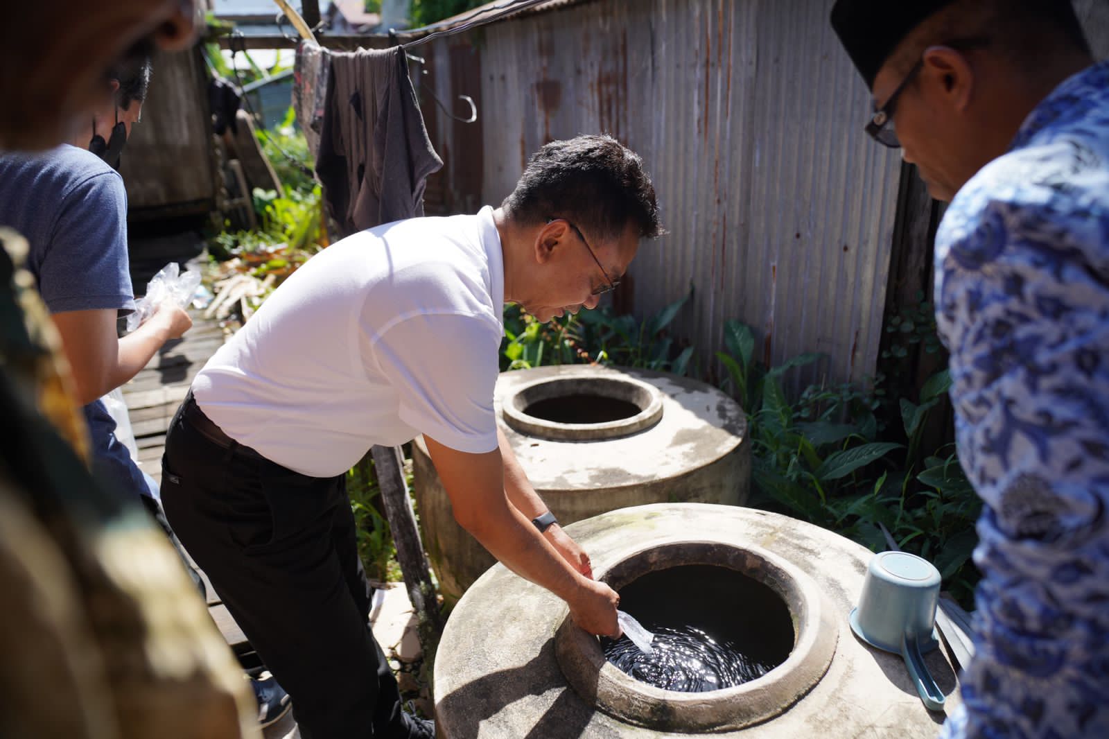 Wali Kota Pontianak, Edi Rusdi Kamtono menaburkan bubuk abate dan ikan cupang pada tempat-tempat penampungan air milik warga. (Foto: Prokopim Pontianak)