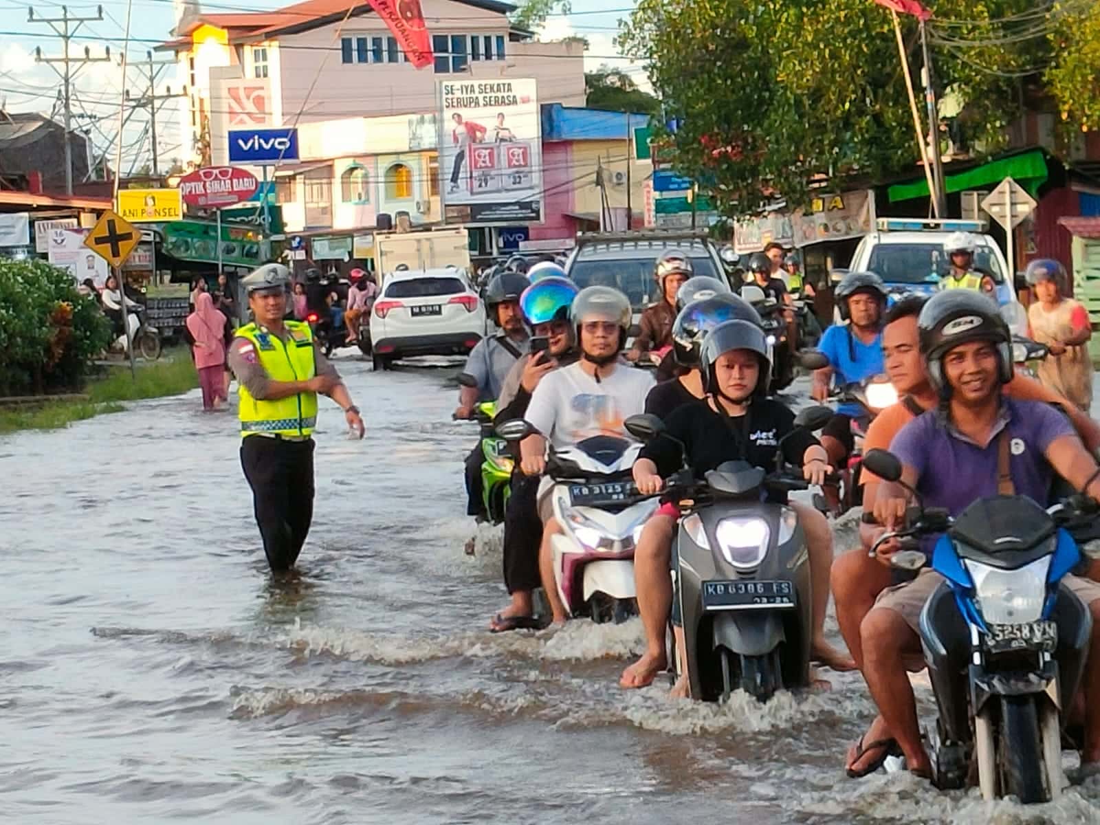 Petugas Satlantas Polres Kapuas Hulu mengatur lalu lintas di ruas jalan yang terdampak banjir di Kota Putussibau. (Foto: Ishaq)